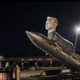 A silver sculpture of Elon Musk's head on a goat's body riding a rocket is shown.